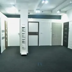 Salon z drzwiami i klamkami, prezentujący różne modele drzwi wewnętrznych i zewnętrznych.